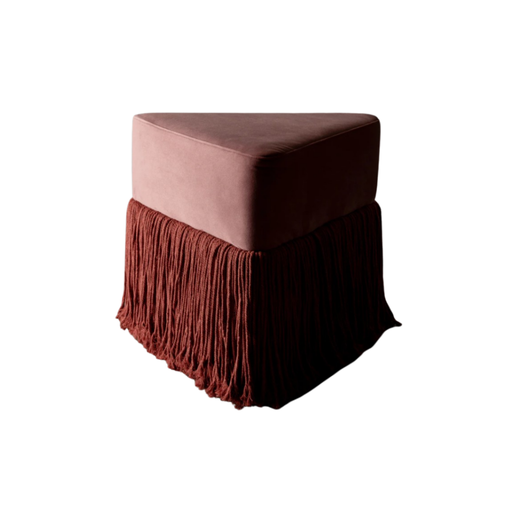 Rachel Donath's Allard Ottoman features a triangular velvet form with cascading tassel fringe, available in six jewel-toned hues, offering a sculptural accent or soft seating solution.