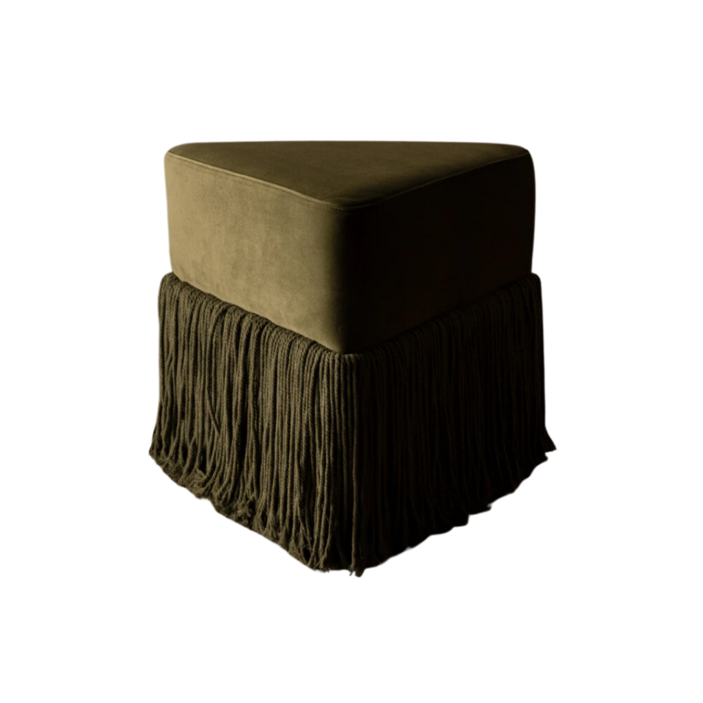Rachel Donath's Allard Ottoman features a triangular velvet form with cascading tassel fringe, available in six jewel-toned hues, offering a sculptural accent or soft seating solution.