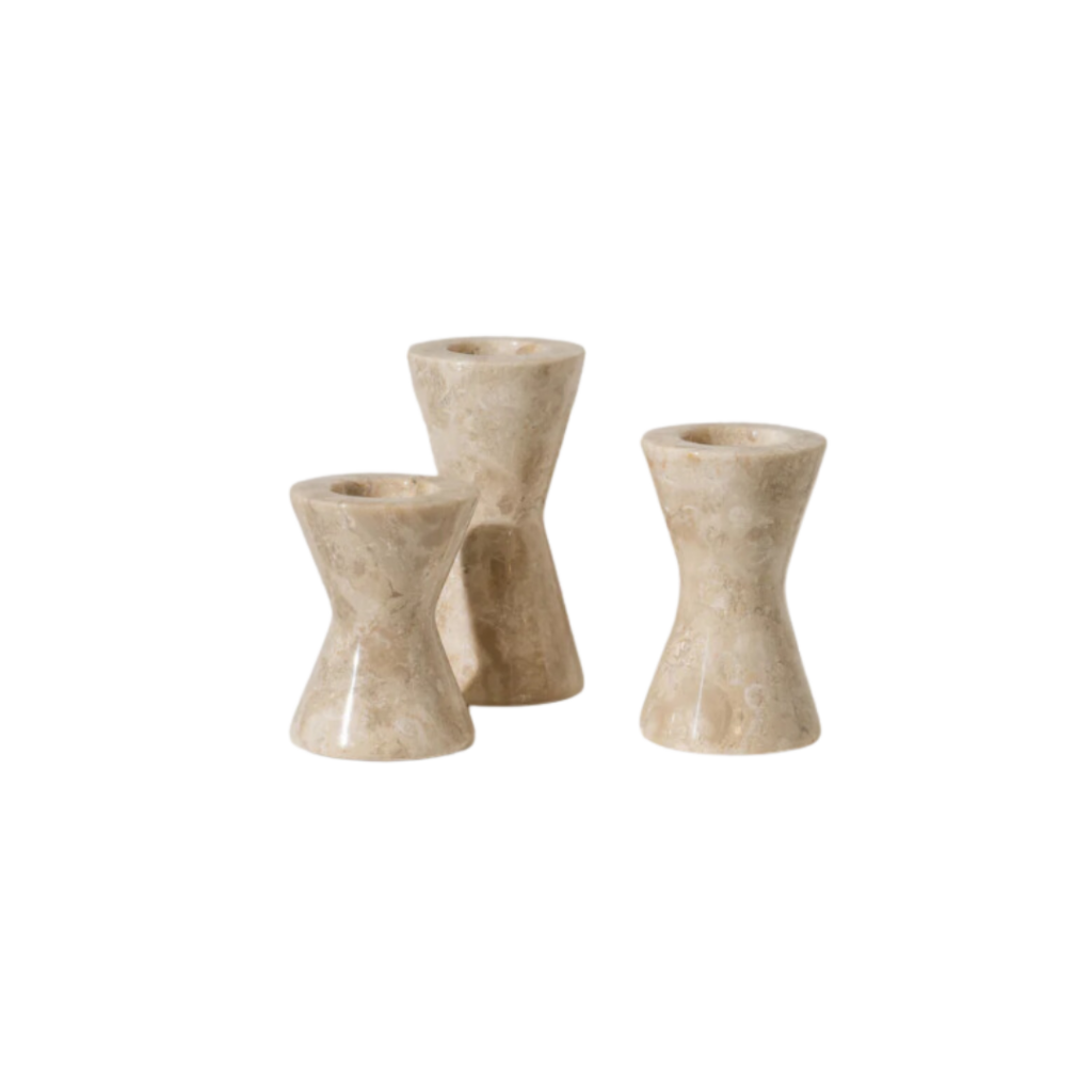 Inartisan Bari Travertine Candle Holder featuring a sculptural hourglass shape in natural travertine stone, each piece uniquely patterned with earthy tones and subtle veining, adding a touch of organic elegance to any space.