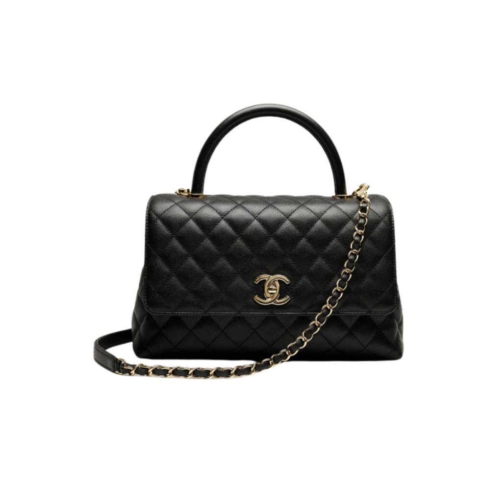 A sophisticated black flap bag featuring a top handle and gold-tone metal hardware, crafted from grained calfskin. The bag showcases CHANEL's iconic quilted pattern and the signature interlocking CC logo, offering both elegance and functionality.