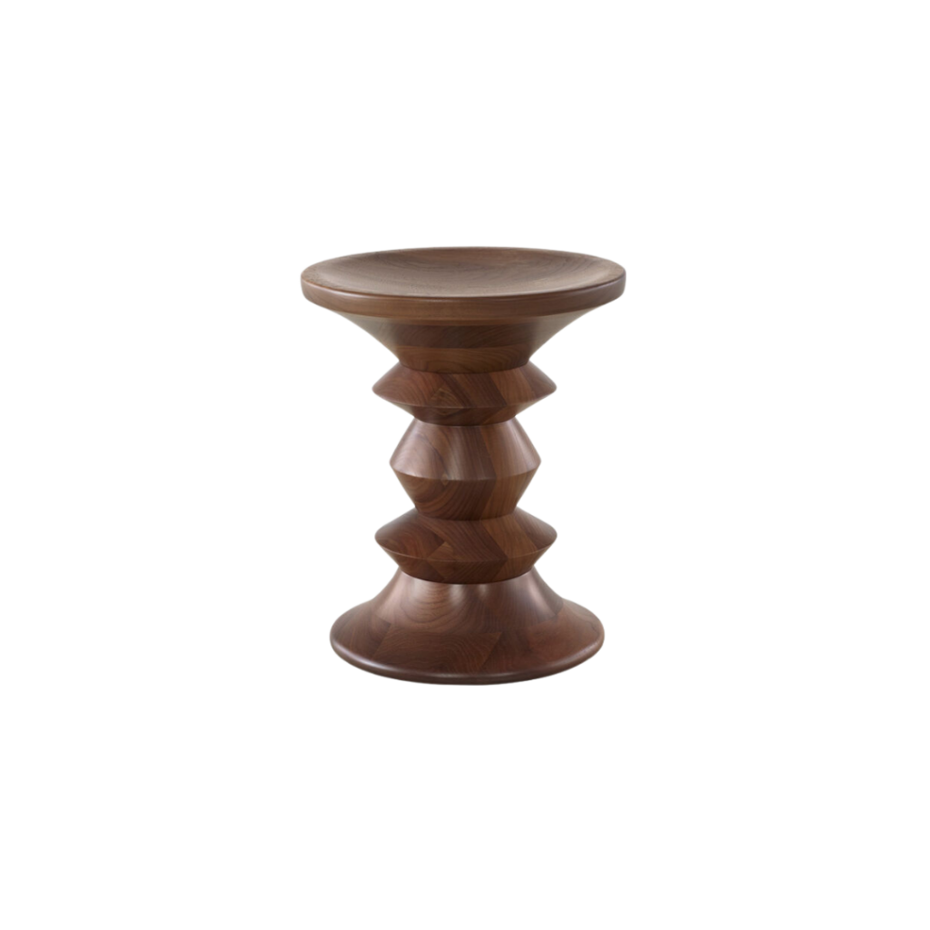 The Eames Turned Stool, designed by Charles and Ray Eames in 1960, is a versatile piece that serves as both a seat and a side table. Crafted from solid walnut, it features concave ends, allowing it to be flipped to suit your preference.