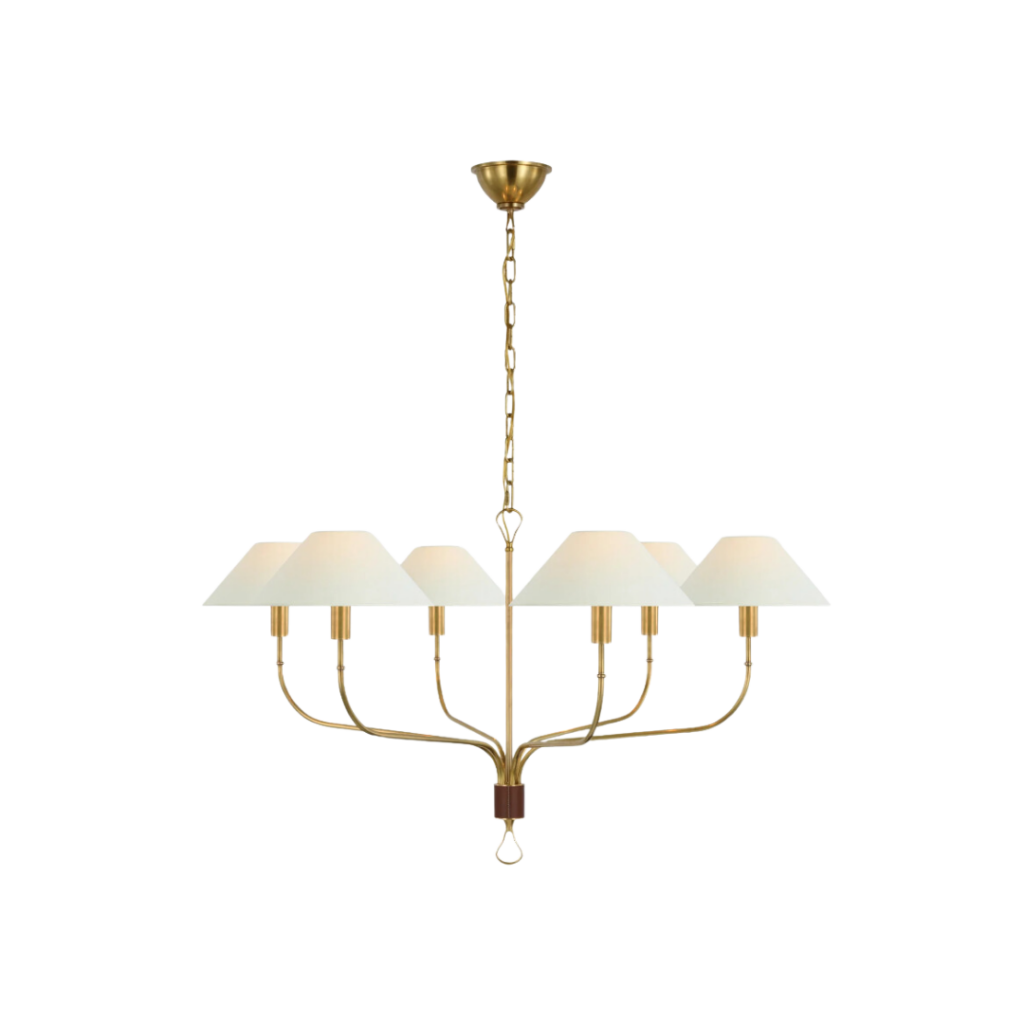 The Griffin Extra Large Tail Chandelier, designed by Amber Lewis for The Montauk Lighting Co., features a sweeping form with leather-wrapped metal arms and linen shades, providing soft illumination ideal for entry foyers, living rooms, or dining areas.