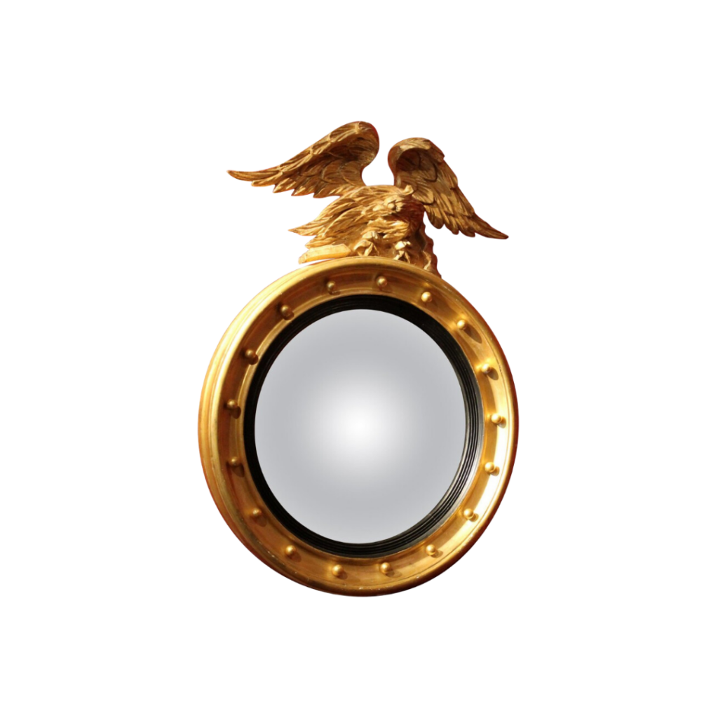 Italian Regency convex mirror featuring a giltwood and ebonised frame adorned with a carved eagle crest, original mercury glass, and decorative gilt spheres.​