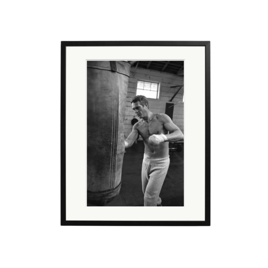 Sonic Editions’ photograph of Steve McQueen boxing, captured in black and white, showcasing the actor’s dynamic energy and iconic style.