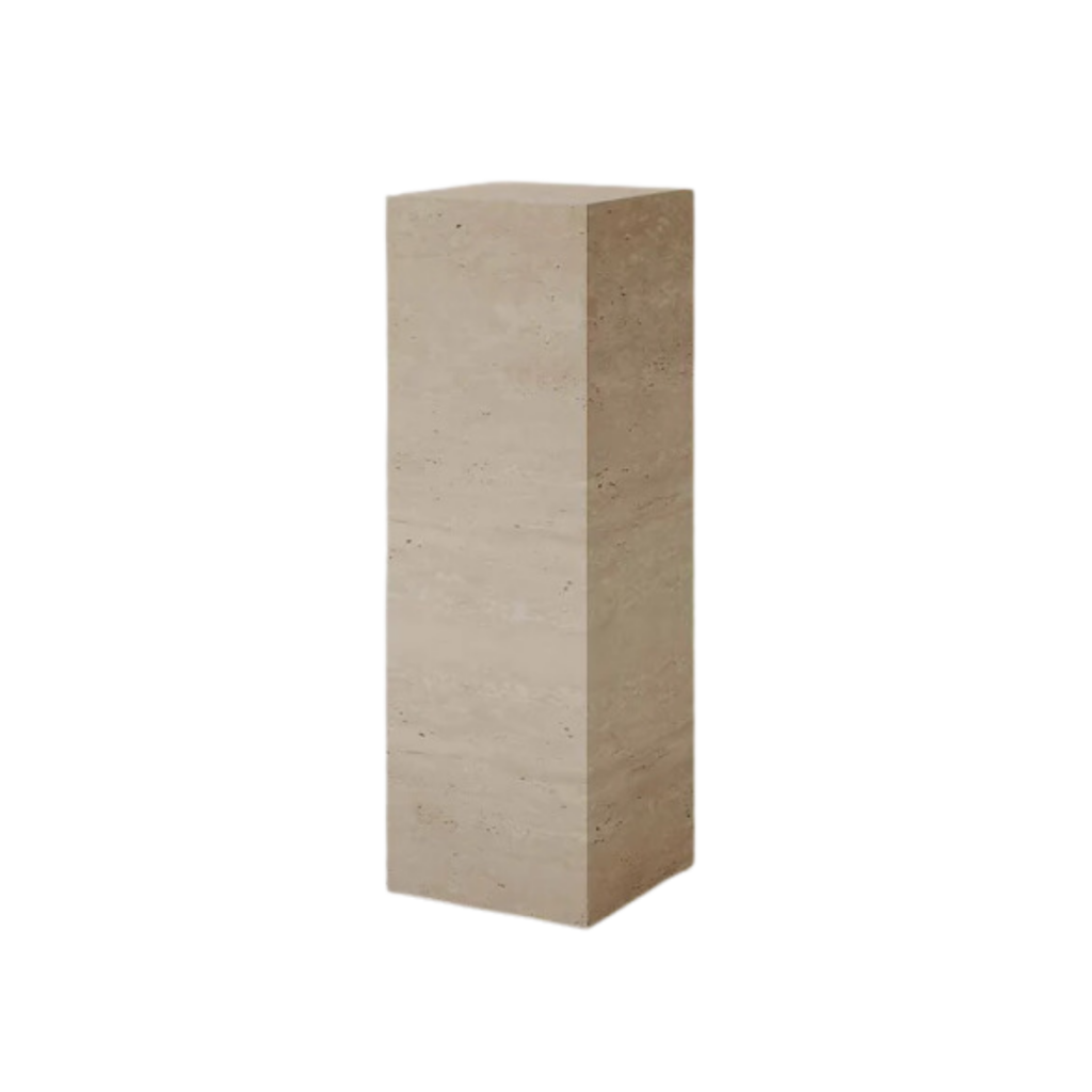 Fleur Studios' Plinth Tall Cream Travertine, a marble side table with a smooth polished finish. Handcrafted from Italian cream travertine, it features soft cream, taupe, and light tan tones, bringing relaxed elegance to any space.