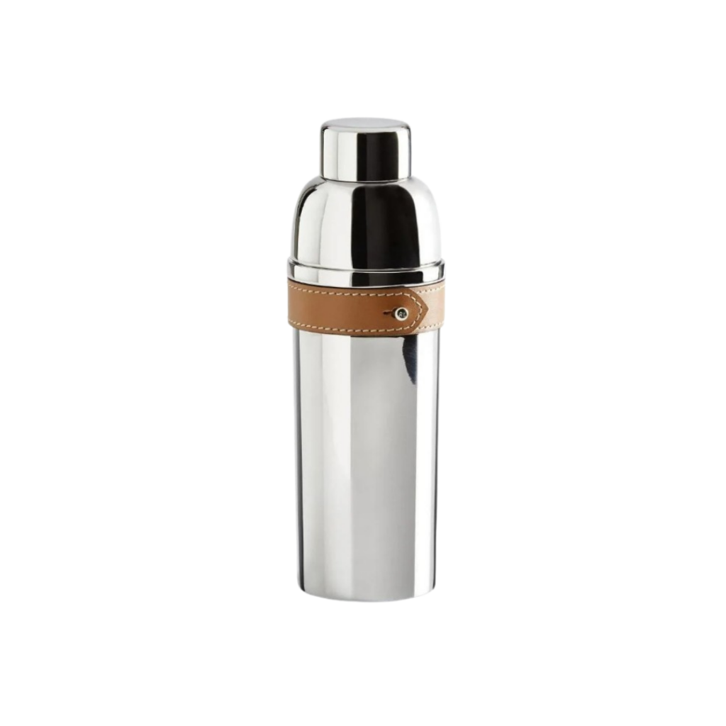 A sleek cocktail shaker featuring a polished stainless steel body with a contrasting leather band, reflecting Ralph Lauren's signature equestrian-inspired design. This elegant piece combines functionality with timeless style, making it a standout addition to any home bar.