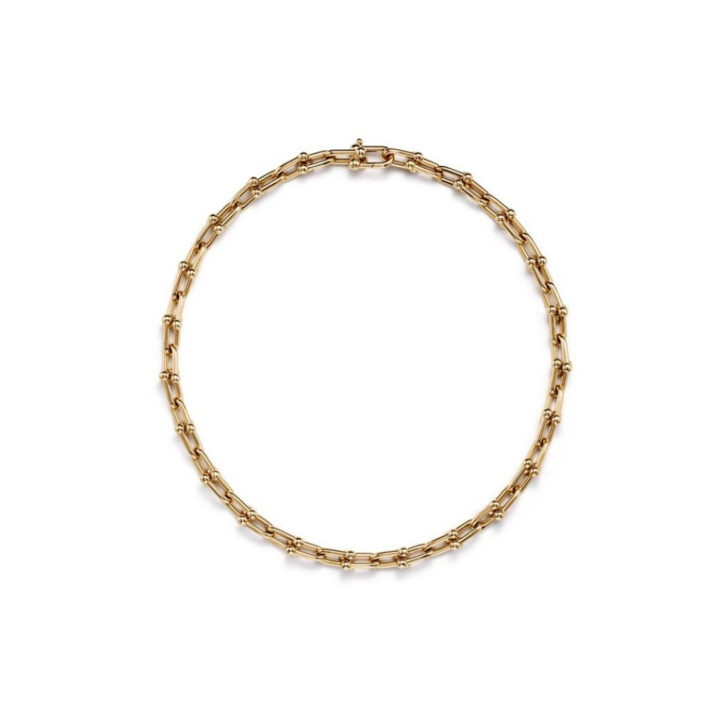 An 18-inch necklace featuring medium-sized links in 18k yellow gold, inspired by a 1962 bracelet from Tiffany's archives. The design embodies enduring resilience and uninhibited spirit, making a bold statement. Comfortable and easy to wear, it is a timeless addition to any collection.