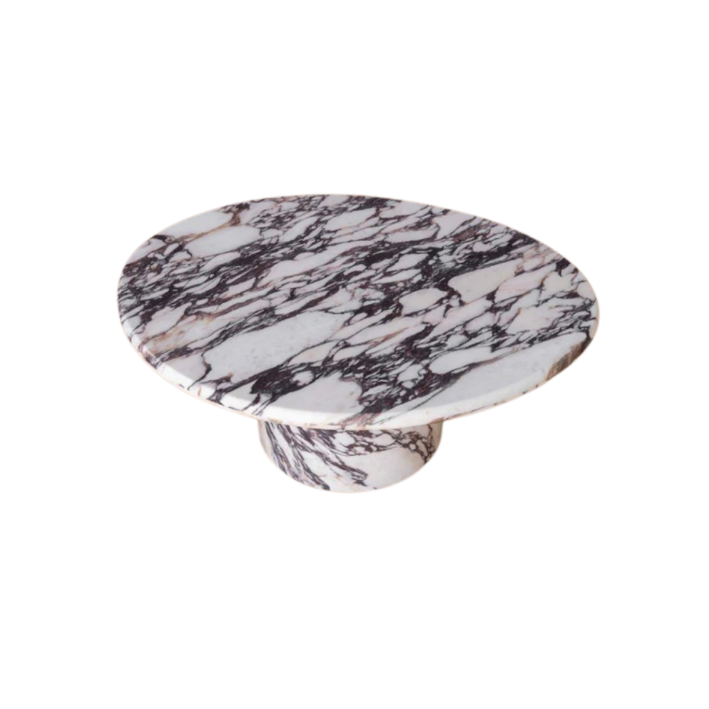 The Wabi Large Round Coffee Table by Fleur Studios, crafted from Italian Calacatta Viola marble, features an organic-shaped tabletop with soft rounded edges and a single column leg. Its ivory base with violet chainlink patterns adds a touch of luxury to any living space.