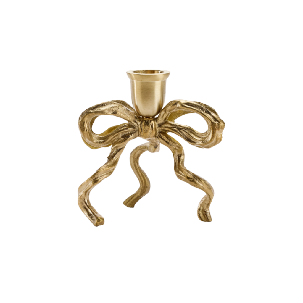Handcrafted brass candle holder featuring a sculptural bow design with gracefully curved ribbons, adding a touch of elegance and charm to any interior setting.